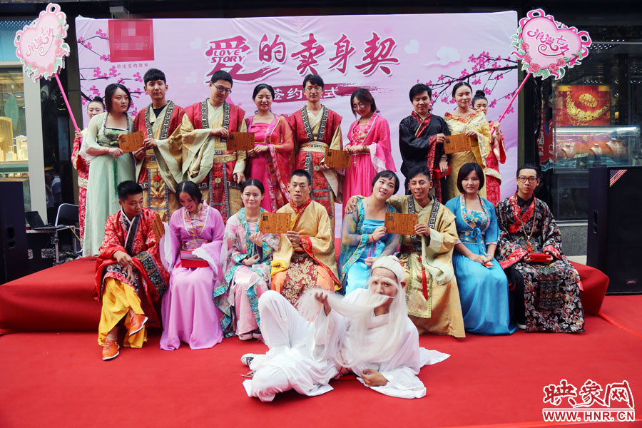 現(xiàn)場8對兒年輕男女舉起“賣身契”集體拍照。