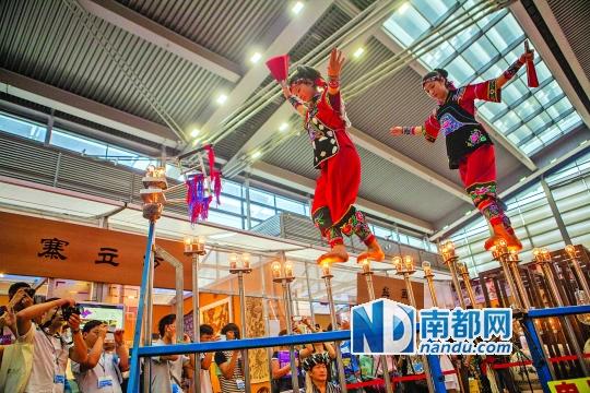 2號(hào)展館，苗族姑娘表演踩燈泡絕技《電光玫瑰》，赤腳踩上40瓦的燈泡并做出高難度動(dòng)作。 南都記者 霍健斌 攝