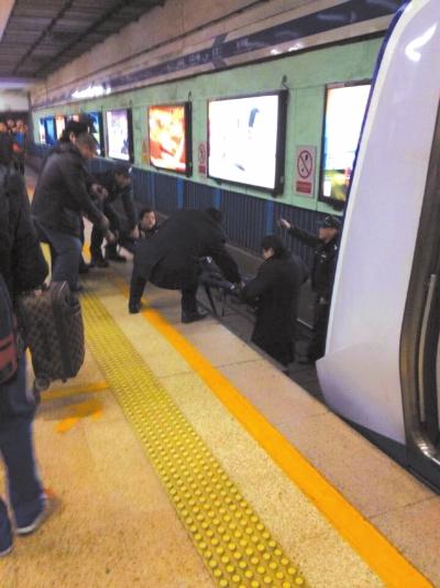 地鐵工作人員將林某從站臺下救起。網(wǎng)友供圖