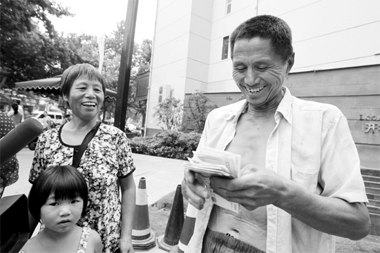 昨日，鄭州市明達(dá)路與豐慶路交叉口西300米路南，來(lái)自中牟的瓜農(nóng)拿到西瓜款，笑開顏東方今報(bào)記者袁曉強(qiáng)